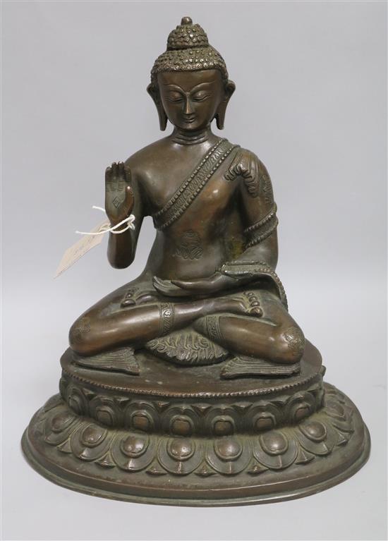 A Nepalese or Tibetan bronze seated model of Buddha